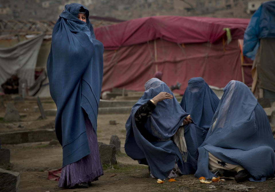 In this Friday, March 7, 2014 photo, Afghan women gather at a cemetery in the center of Kabul, Afghanistan. A gender and development specialist and human rights activist, Afghan Wazhma Frogh says her experience characterizes the women’s rights movement in her country- after 12 years, billions of dollars and countless words emanating from the West commiserating with Afghan women, the successes are fragile, the changes superficial and vulnerable. (AP Photo/Anja Niedringhaus)