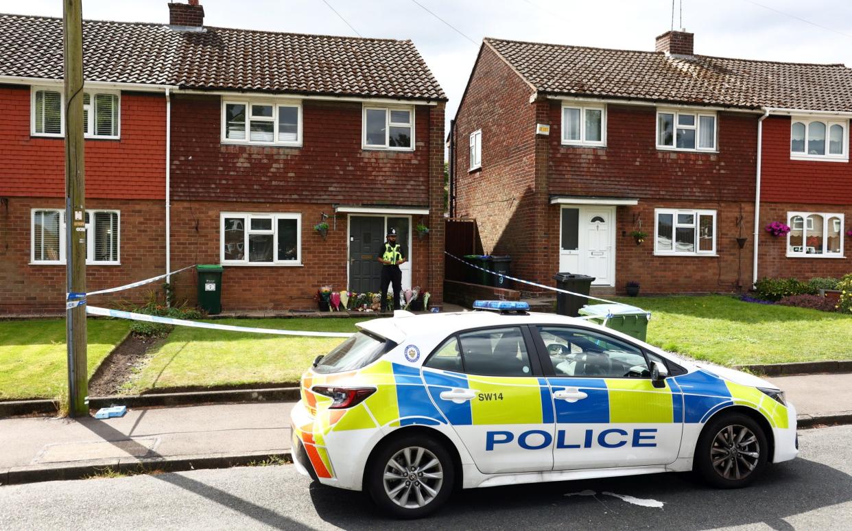 Police stand guard and floral tributes laid at house where boy was stabbed