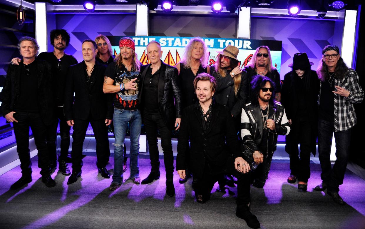 Rick Allen, Tommy Lee, Vivian Campbell, Joe Elliott, Bret Michaels, Phil Collen, Rick Savage, Rikki Rokkett (kneeling), C.C. DeVille, Nikki Sixx (kneeling), Vince Neil, Mick Mars and Bobby Dall pose together following a news conference to announce The Stadium Tour.