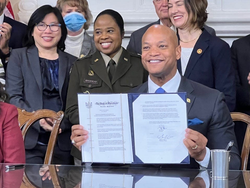 Maryland Gov. Wes Moore, a Democrat, holds an executive order he signed on artificial intelligence while cabinet secretaries and legislators surround him on in Annapolis Monday, Jan. 8, 2024. Behind Moore from left, state Secretary of Labor Portia Wu, state Secretary of Disabilities Carol Beatty (with mask), Major General Janeen Birckhead, state Secretary of Emergency Management Russell Strickland, and state Sen. Katie Fry Hester, D-Howard/Montgomery.