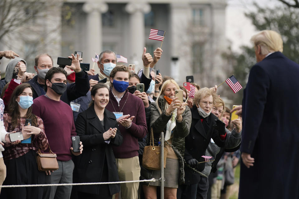 FILE - In this Dec. 12, 2020, file photo supporters greet President Donald Trump as he walks on the South Lawn of the White House in Washington before boarding Marine One. (AP Photo/Patrick Semansky, File)