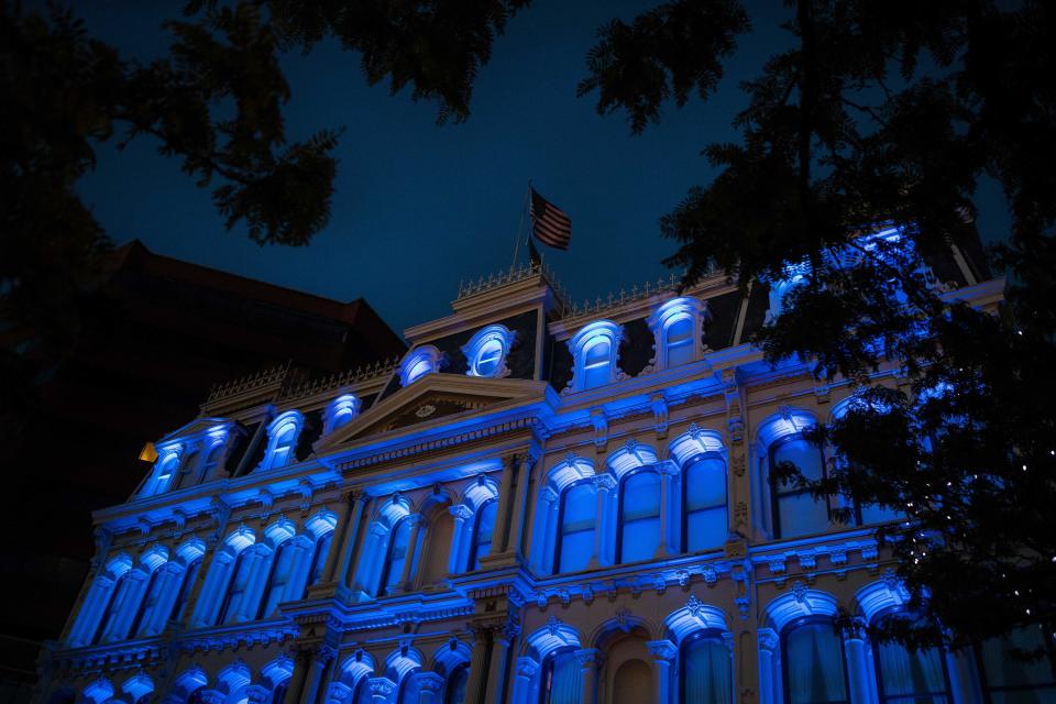 Blue lights illuminate The Grand in honor of first responders on the front lines of the coronavirus pandemic in May 2020 in Wilmington.