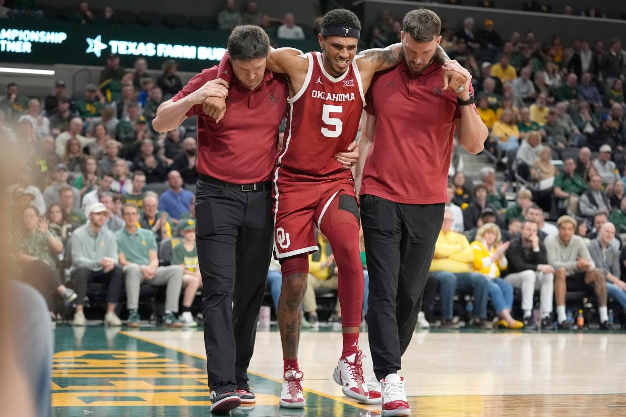Oklahoma guard Rivaldo Soares (5) is helped off the court during the second half of the team's NCAA college basketball game against Baylor on Tuesday, Feb. 13, 2024, in Waco, Texas. (AP Photo/LM Otero)