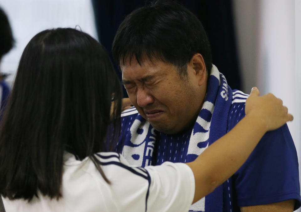 <p>A Japanese fan cries during the broadcast of the FIFA World Cup soccer match. REUTERS/Paulo Whitaker </p>