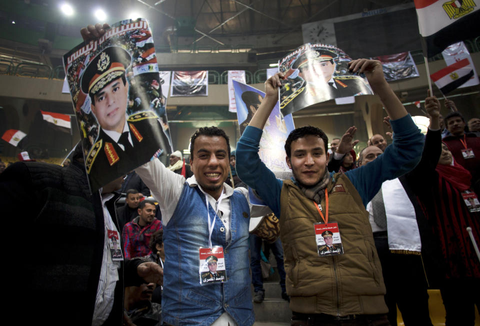 Egyptians hold posters of Egypt's Defense Minister, Gen. Abdel-Fattah el-Sissi, with Arabic writing that reads, "el-Sissi is my president," during a rally in support of el-Sissi, in Cairo, Egypt, Tuesday, Jan. 21, 2014. Supporters of the powerful army chief and defense minister urged Egyptians on Tuesday to turn the third anniversary to 2011 uprising that toppled longtime autocratic president Hosni Mubarak, to a show of gratitude to the general for ousting Islamist president, calling on him to contest elections. (AP Photo/Khalil Hamra)