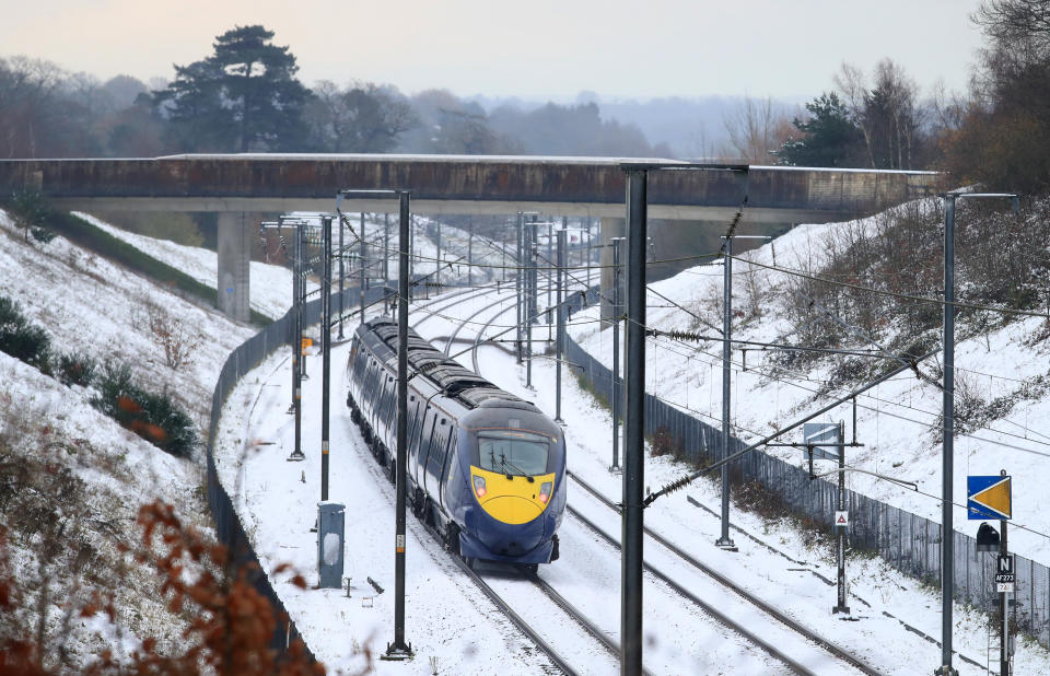 A train passes through Ashford in Kent following overnight rain and snow. (Photo by Gareth Fuller/PA Images via Getty Images)