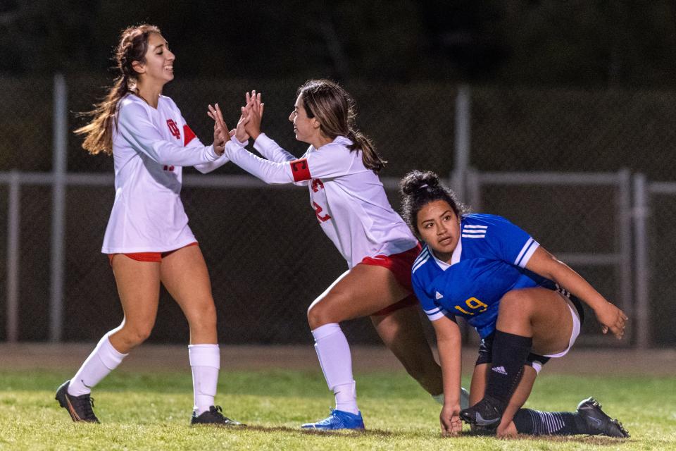 Oak Hills' Sydney Middaugh, center, celebrates with Alexia Garcia after scoring against Serrano during the second half in Phelan on Wednesday, Jan. 19, 2022. Oak Hills won 4-0.