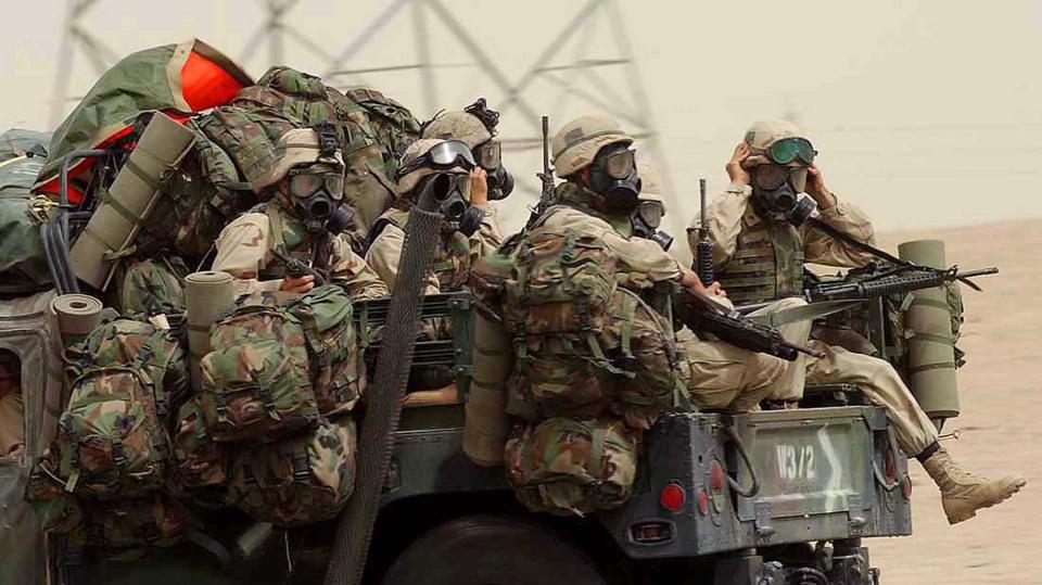 U.S. troops in protective NBC (Nuclear, Biological and Chemical) suits
make their way in a mass convoy through northern Kuwait towards Iraq,
March 20, 2003. Britain said its troops were on full alert and ready
for a rapidly escalating Iraq war, denying the United States had
sidelined its top ally with Thursday's unilateral raid on Baghdad.
REUTERS/POOL/Jon Mills

ASA/WS