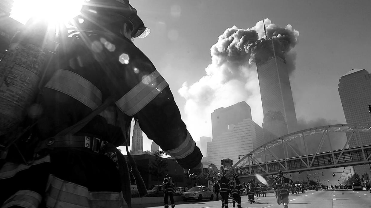 Firefighters walk toward one of the towers at the World Trade Center before it collapsed on Sept. 11, 2001, in New York City. 