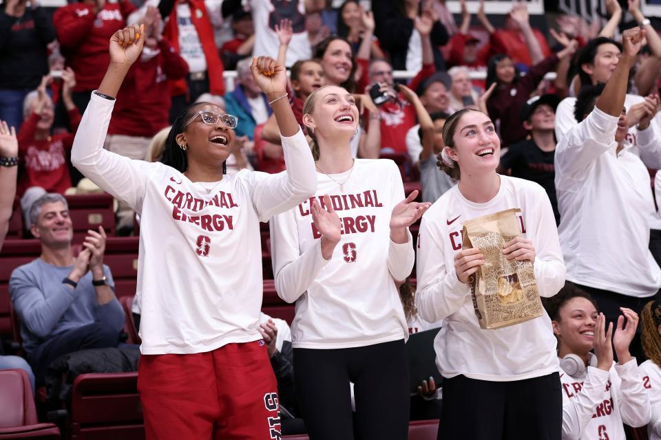 Stanford's Cameron Brink, center, and teammates Kiki Iriafen, left, and Brooke Demetre react to being named a No. 2 seed in the NCAA tournament, Sunday, March 17, 2024.