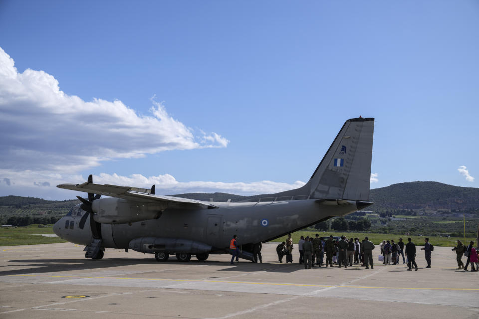 Passengers from Sudan disembark a military plane at Tanagra air base, north of Athens on Wednesday, April 26, 2023. Sixteen Greeks and one Cypriot arrived in Greece after being evacuated from Sudan. (AP Photo/Thanassis Stavrakis)
