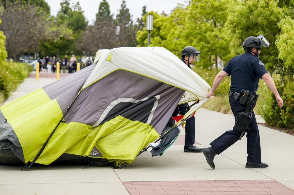 Police drag away a tent from a pro-Palestinian encampment at the University of California, Irvine on May 15, 2024. <a href="https://www.gettyimages.com/detail/news-photo/police-drag-away-a-tent-from-the-pro-palestinian-encampment-news-photo/2153726114?adppopup=true" rel="nofollow noopener" target="_blank" data-ylk="slk:Leonard Ortiz/MediaNews Group/Orange County Register via Getty Images;elm:context_link;itc:0;sec:content-canvas" class="link ">Leonard Ortiz/MediaNews Group/Orange County Register via Getty Images</a>