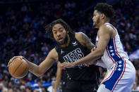 Brooklyn Nets' Trendon Watford, left, tries to get to the basket with Philadelphia 76ers' Tobias Harris, right, defending during the first half of an NBA basketball game, Sunday, April 14, 2024, in Philadelphia. (AP Photo/Chris Szagola)