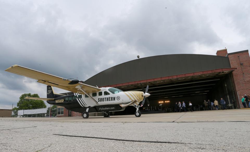 People gather at the Purdue University airport's groundbreaking event for the new Amelia Earhart Terminal and inaugural flight of Southern Airways's new Purdue-themed aircraft, on Tuesday, May 14, 2024, in West Lafayette, Ind.
