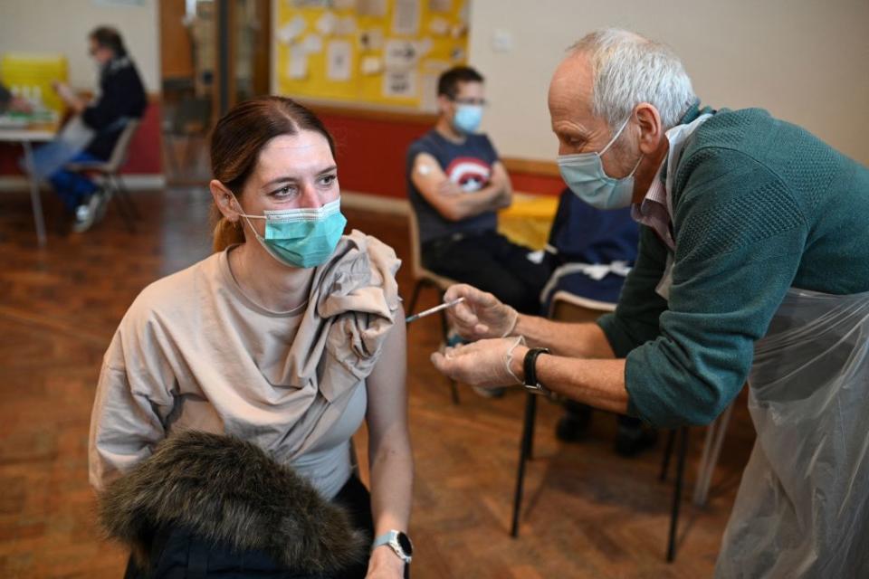 A woman receives a dose of the Pfizer Covid-19 vaccine in a vaccination clinic set up at St Columba's Church in Sheffield.