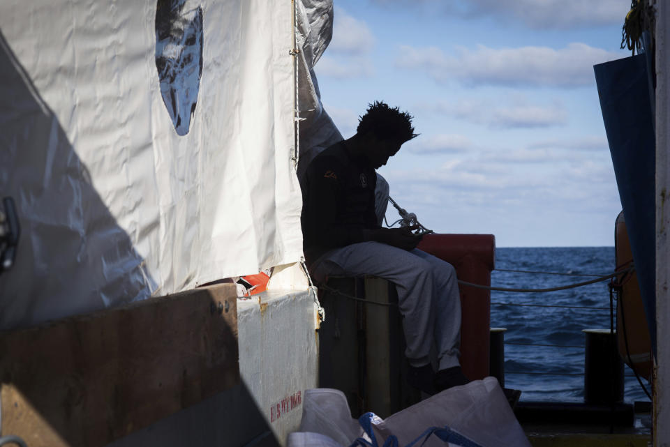 In this Monday, Dec. 24, 2018 photo and provided by Sea Watch, a migrants sits aboard the rescue ship Sea-Watch 3. Over 30 migrants saved in the central Mediterranean sea by the German no-profit rescue organization Sea-Watch are still stranded after five days at sea, because no European country is opening its ports to receive them. (Chris Grodotzki/Sea Watch Via AP)