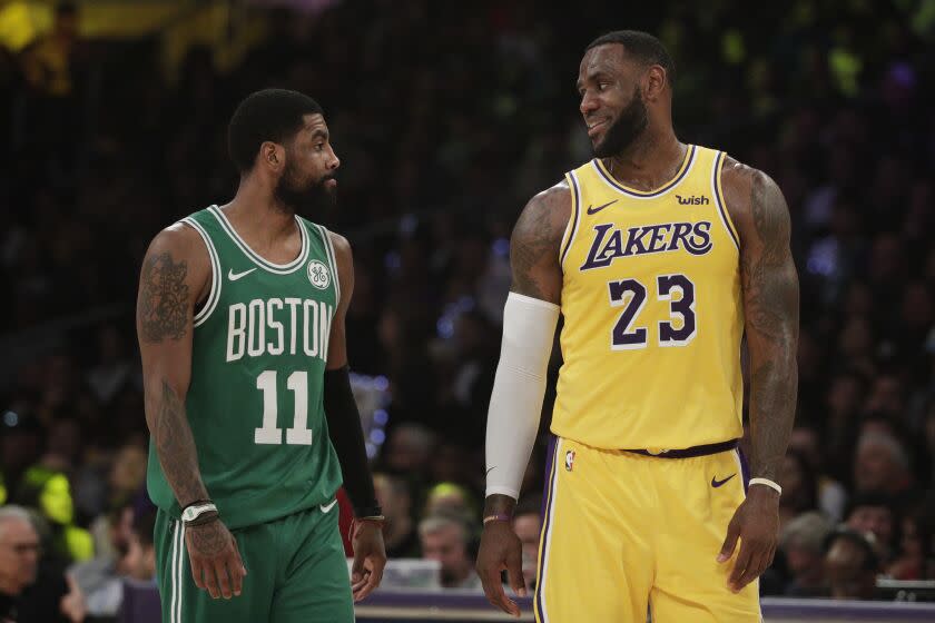 Los Angeles Lakers' LeBron James, right, and Boston Celtics' Kyrie Irving chat during the first half of an NBA basketball game, Saturday, March 9, 2019, in Los Angeles. (AP Photo/Jae C. Hong)