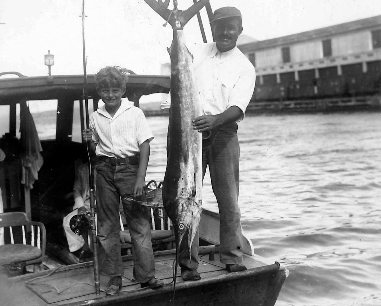 <span class="caption">Hemingway and his eldest son, Bumby, pose in Havana harbor in 1933.</span> <span class="attribution"><span class="source">Collection of David Meeker</span>, <span class="license">Author provided</span></span>