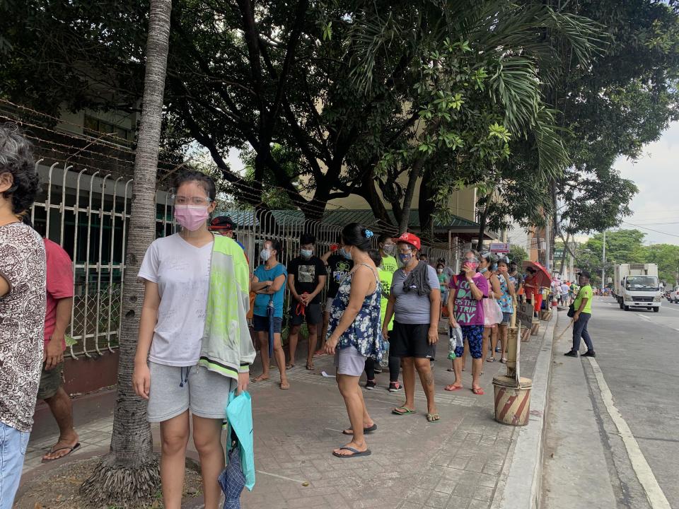 Filipinos line up at the Maginhawa community pantry in Quezon City, outside the capital city of Manila, Philippines, to receive food, April 26, 2021. / Credit: CBS/Barnaby Lo