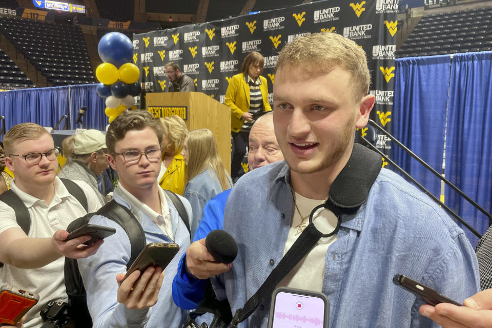 Tucker DeVries talks to reporters after a news conference where his father, Darian DeVries, was introduced as the new West Virginia NCAA college basketball coach Thursday, March 28, 2024, in Morgantown, W.Va. Tucker DeVries announced that he will transfer from Drake to continue playing for his father. (AP Photo/John Raby)