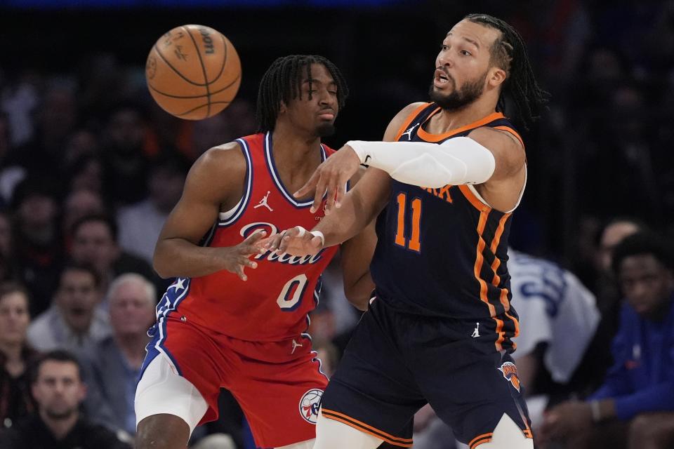 New York Knicks' Jalen Brunson (11) passes away from Philadelphia 76ers' Tyrese Maxey (0) during the first half of Game 2 in an NBA basketball first-round playoff series, Monday, April 22, 2024, in New York. (AP Photo/Frank Franklin II)