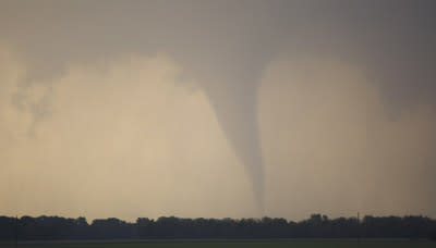 A tornado forms and touches down north of Soloman, Kan., Saturday, April 14, 2012. (AP Photo/Orlin Wagner)