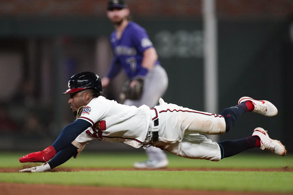 Atlanta Braves second baseman Ozzie Albies (1) slides into second before being tagged out in the fifth inning of a baseball game against the Colorado Rockies Tuesday, Sept. 14, 2021, in Atlanta. (AP Photo/John Bazemore)