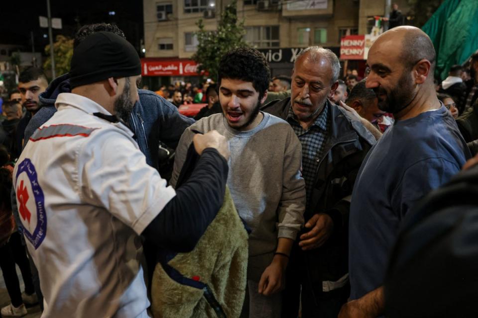 A Palestinian man is welcomed home in the West Bank in the early hours of Sunday (AFP)