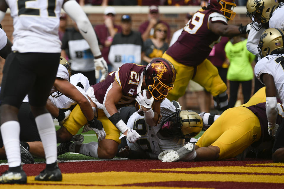 Minnesota running back Bryce Williams, center, dives into the end zone for a touchdown against Purdue during the second half of an NCAA college football game, Saturday, Oct. 1, 2022, in Minneapolis. Purdue won 20-10. (AP Photo/Craig Lassig)