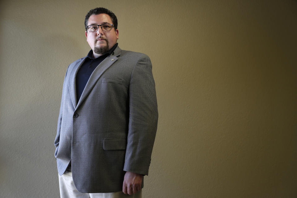 In this July 19, 2019, photo, Ferguson Mayor James Knowles III poses for a photo in St. Peters, Mo. Knowles was re-elected to a third three-year term last year. He said the election was evidence that despite those who speak out at council meetings, he has plenty of support, including in the black community. (AP Photo/Jeff Roberson)