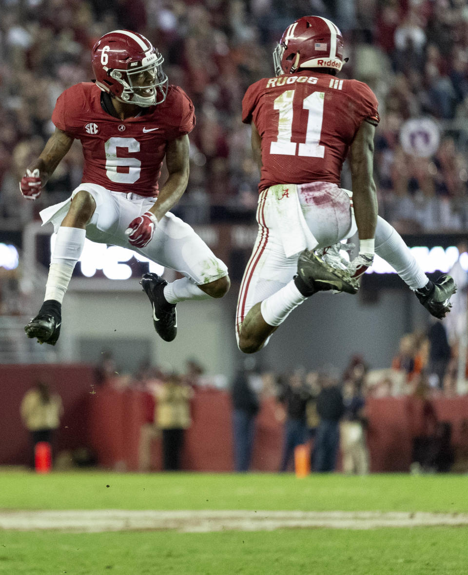 FILE - In this Saturday, Nov. 24, 2018, file photo, Alabama wide receivers DeVonta Smith (6) and Henry Ruggs III (11) celebrate a touchdown reception by Ruggs during the second half of an NCAA college football game against Auburn in Tuscaloosa, Ala. The Tide hasn't had a Top 15 offense under coach Nick Saban. Enter Tua Tagovailoa. And Jerry Jeudy. And fellow receivers Henry Ruggs III, DeVonta Smith and freshman Jaylen Waddle. Plus tight end Irv Smith Jr. Not to mention tailbacks Damien Harris, Najee Harris and Josh Jacobs. (AP Photo/Vasha Hunt, File)