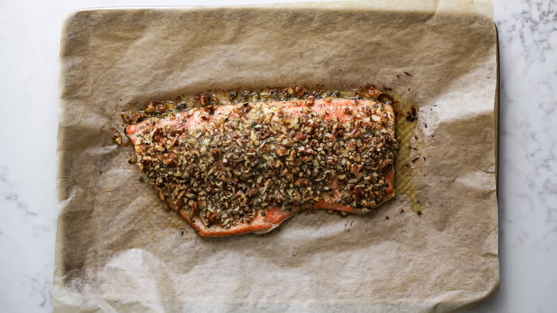 cooked walnut and sage-crusted salmon on brown paper