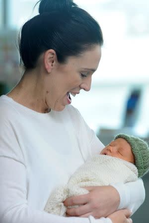 New Zealand Prime Minister Jacinda Ardern carries her newborn baby Neve Te Aroha Ardern Gayford as she walks out of the Auckland Hospital in New Zealand, June 24, 2018. REUTERS/Ross Land