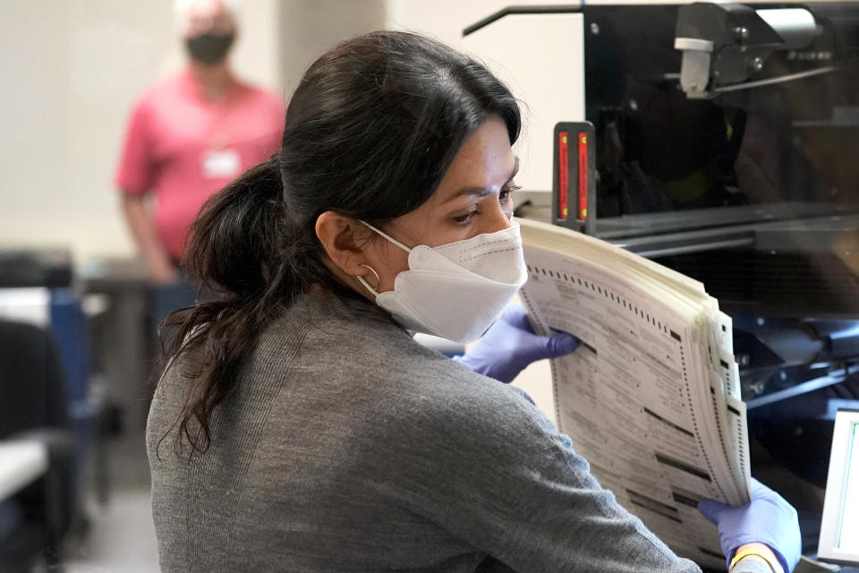 Maricopa County elections officials count ballots, Wednesday, Nov. 4, 2020, at the Maricopa County Recorders Office in Phoenix. (AP Photo/Matt York)