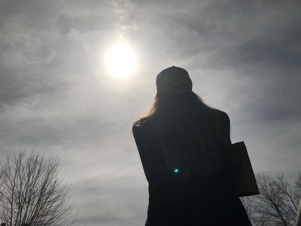 Nicole Tuggle looks into the Ohio sky Monday during the 2024 total solar eclipse.