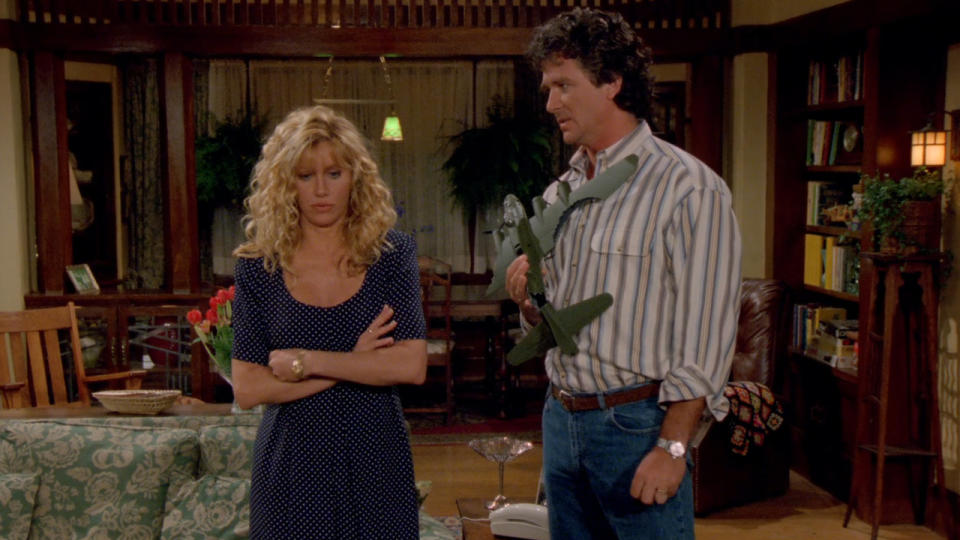 Suzanne Somers looks disappointed as Patrick Duffy stands holding a plane in Step By Step.