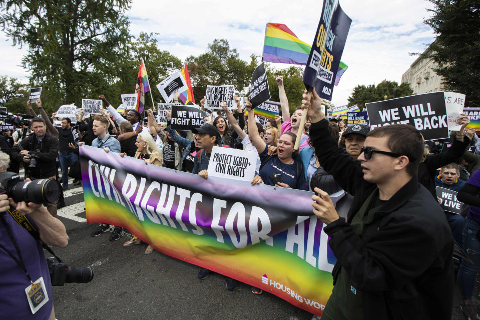 FILE - In this Oct. 8, 2019 file photo, supporters of LGBT rights stage a protest on the street in front of the U.S. Supreme Court in Washington. A group launched a 2020 ballot initiative Tuesday, Jan. 7, 2019, to expand Michigan's civil rights law to include anti-discrimination protections for LGBT people, a step that would put the issue to voters if the Republican-led Legislature does not pass the measure. (AP Photo/Manuel Balce Ceneta,File)