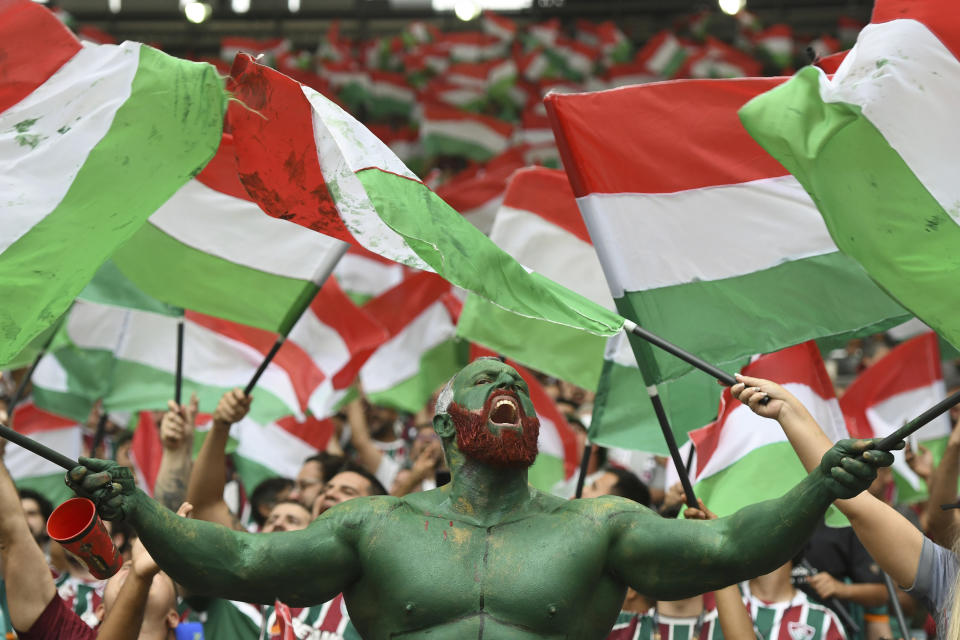 A Brazil Fluminense fan waves team banners prior to the Copa Libertadores final soccer match against Argentina's Boca Juniors, at the Maracana stadium in Rio de Janerio, Brazil, Saturday, Nov. 4, 2023. (AP Photo/Alexandre Brum)