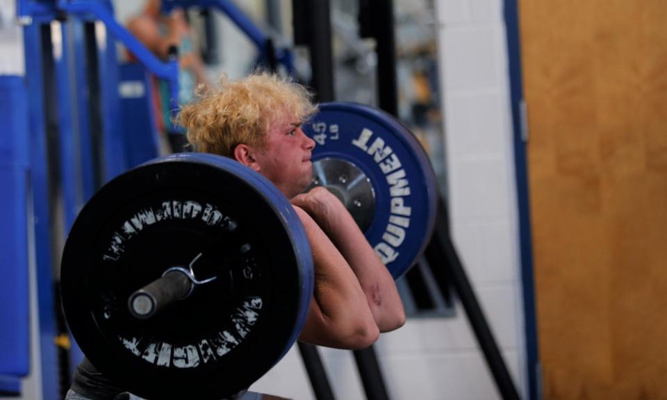 Centerville junior Collin Clark power cleans with his new dyed hairdo June 15, 2022.