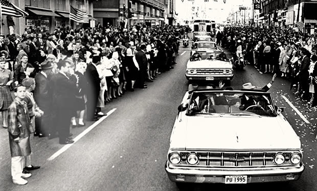 <b class="credit">Courtesy of Bob Huffaker</b>Bob Huffaker is pictured left next to the motorcade on Nov. 22, 1963.