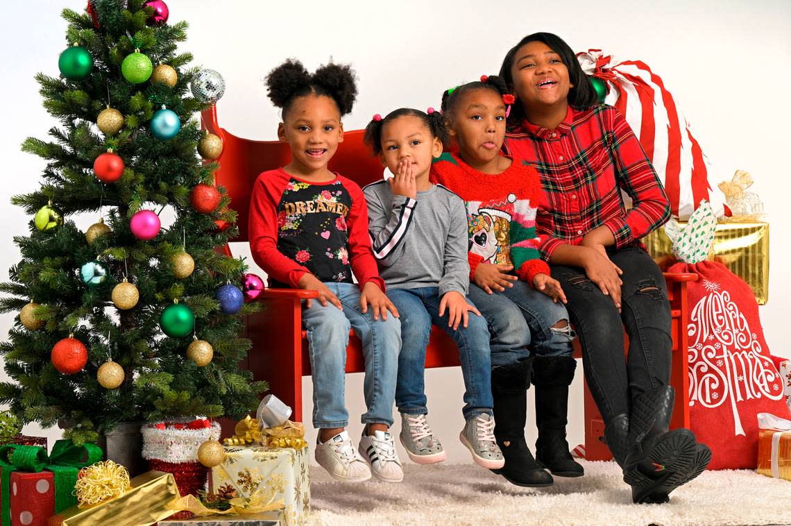 The daughters of Ashley Ramsey of Kansas City enjoyed a visit to the Soul of Santa breakfast on Saturday, where Star reporters, editors and photographers volunteered to create holiday family portraits for some 22 families. The girls, Zera Williams, 4, from left, Marliyah Williams, 3, AmiYah, 5, and Eva Williams, 10, had fun posing with one another. Tammy Ljungblad/tljungblad@kcstar.com