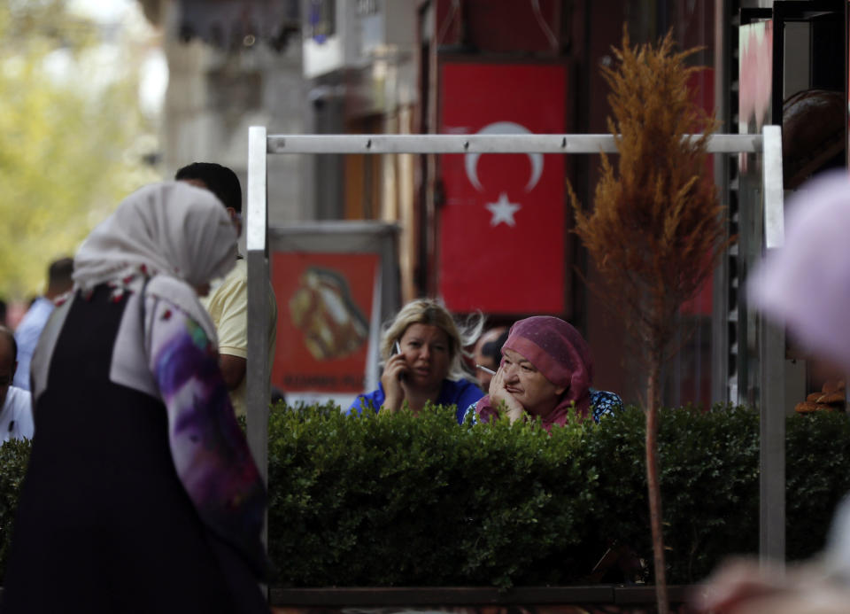 In this photo taken on Tuesday, Aug. 20, 2019, people gather near Fatih mosque in Istanbul. Syrians say Turkey has been detaining and forcing some Syrian refugees to return back to their country the past month. The expulsions reflect increasing anti-refugee sentiment in Turkey, which opened its doors to millions of Syrians fleeing their country's civil war. (AP Photo/Lefteris Pitarakis)