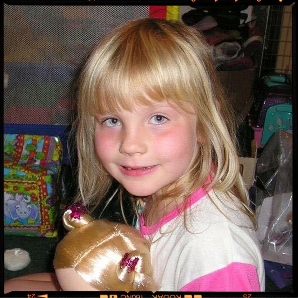 a girl holding a stuffed animal