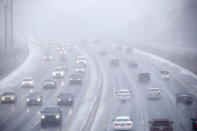 <p>Cars drive along Toronto’s Lakeshore Drive as visibility diminishes through falling hail, snow, and rain in Toronto, Ont. on Saturday, April 14, 2018. (Photo from The Canadian Press/Cole Burston) </p>