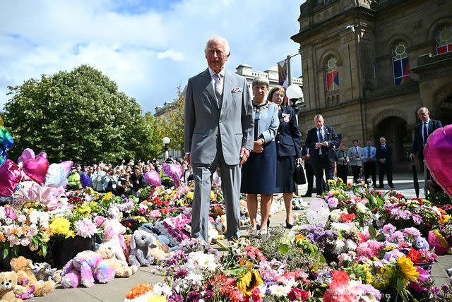 <p>PAUL ELLIS/AFP via Getty</p> King Charles viewing some of the floral tributes in Southport, near Liverpool, on Aug. 20, 2024