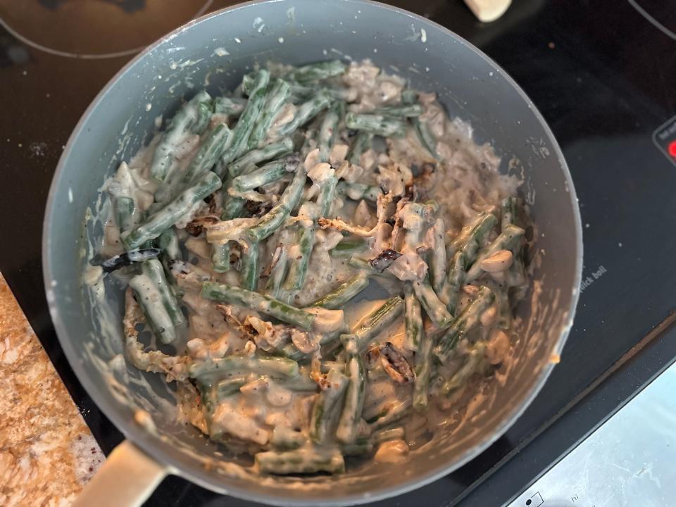 green beans and fried onions in a pan on the stove