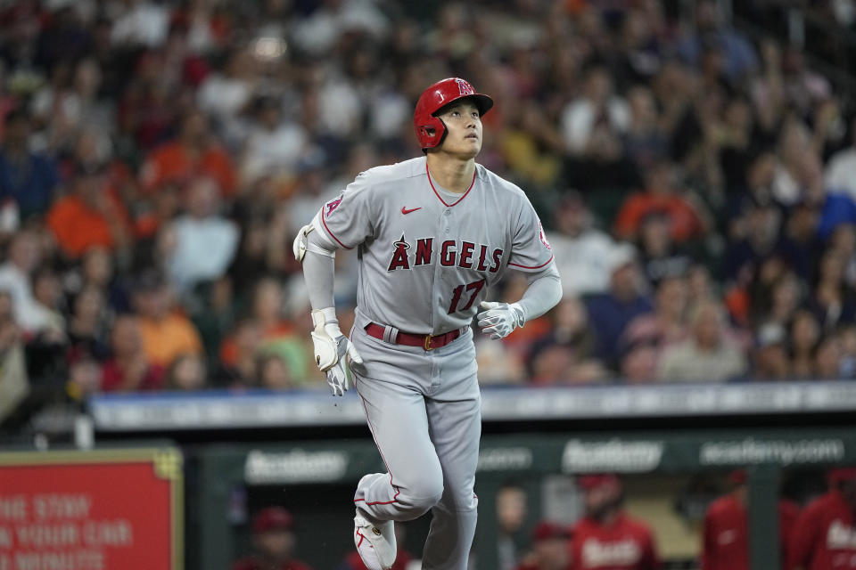 Los Angeles Angels' Shohei Ohtani watches his home run against the Houston Astros during the first inning of a baseball game Friday, July 1, 2022, in Houston. (AP Photo/David J. Phillip)