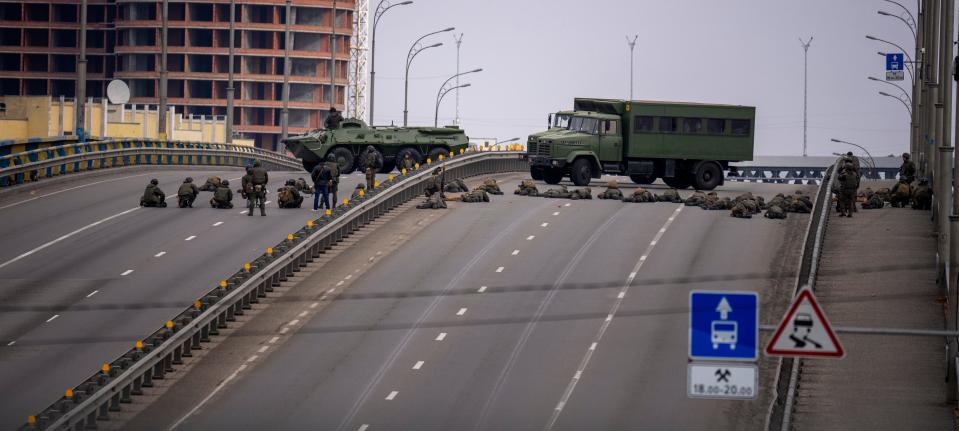 Ukrainian soldiers take position on a bridge inside the Ukrainian capital of Kyiv on Feb. 25, 2022.