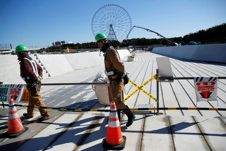 Workers walk at the construction site of the Kasai Canoe Slalom Centre for Tokyo 2020 Olympic games in Tokyo, Japan February 12, 2019. REUTERS/Issei Kato