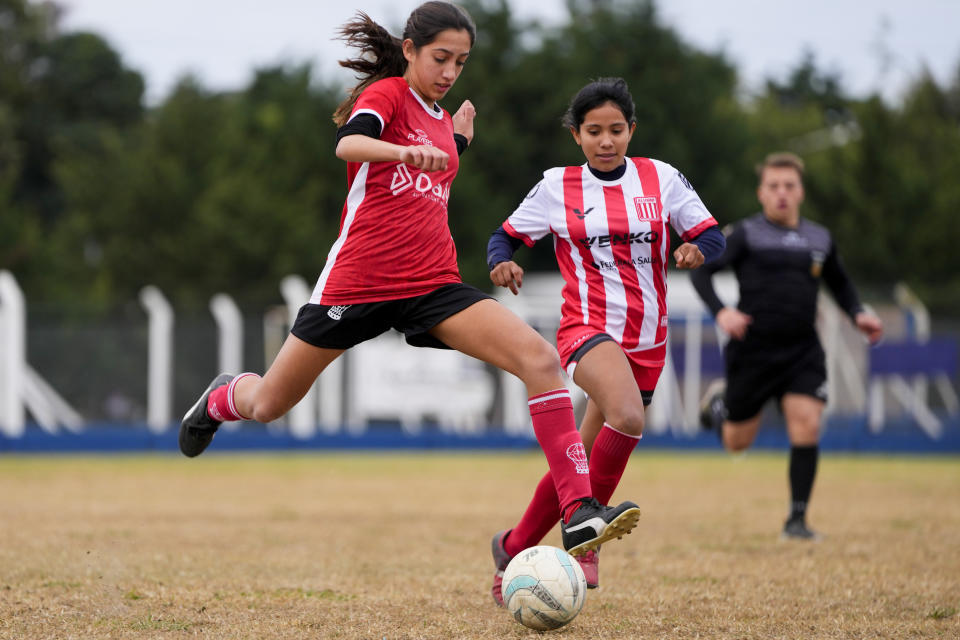 Candelaria Cabrera, a 12-year-old player with the Huracán de Chabas female team, controls the ball during a soccer match against Alumni in Arequito, Santa Fe province, Argentina, Monday, June 19, 2023. In 2018 when she was seven, Candelaria was the only girl playing in a boys league. After a regional sports regulation forbid mixed teams in youth divisions, she and her family had to fight for her right to keep playing. (AP Photo/Natacha Pisarenko)